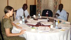 Facilitators and participants in the data-driven decision making workshop working at a table.