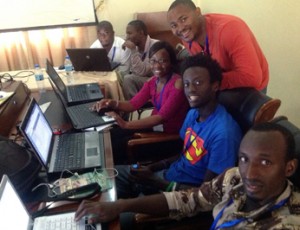 Participants from Tanzania, Botswana and Rwanda talk open-source shop at the first annual iHRIS Academy in Tanzania.